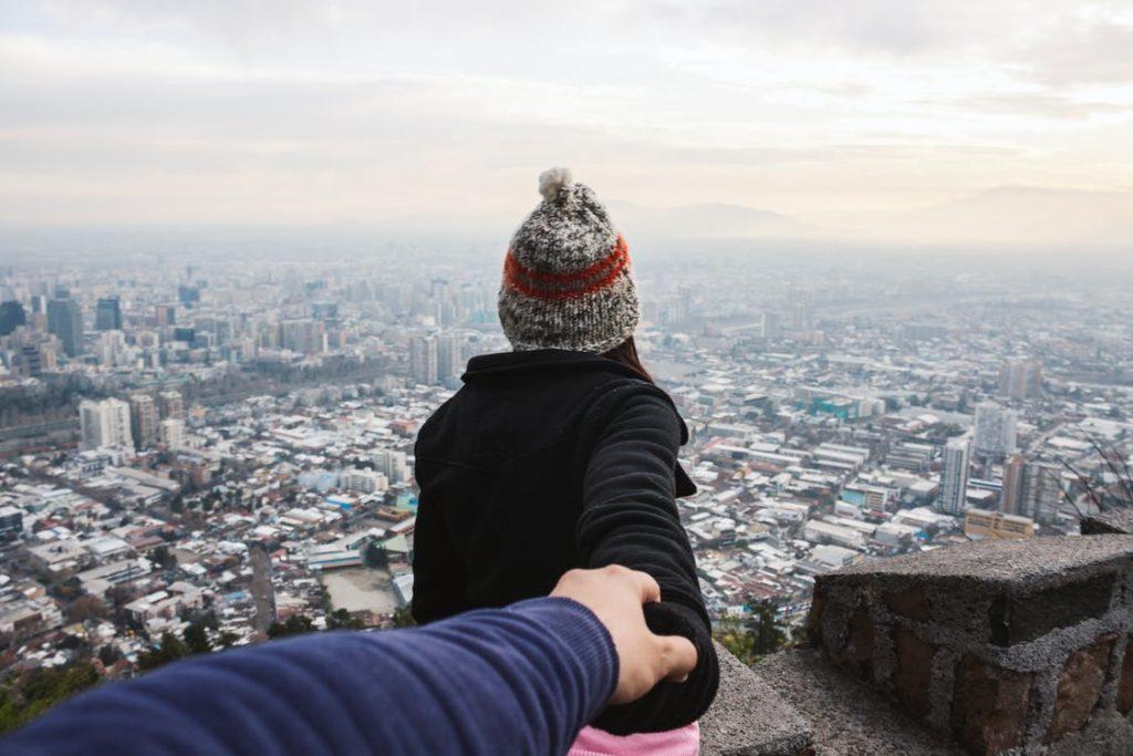 woman holding man's hand for safety