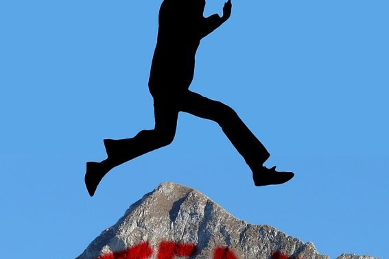 Man jumping over mountain