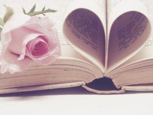 Rose inside book. Pages shaped like heart.
