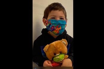 Teddy bear and kid masked