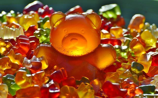 Giant gummy bear escaping from smaller gummies