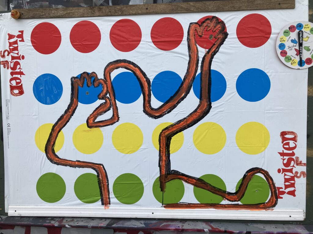 The game of Twister, repurposed as outdoor wall art.