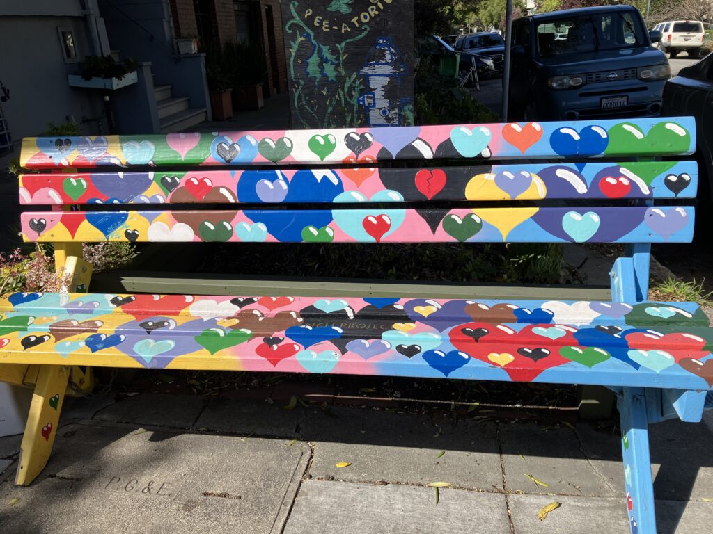 Bench painted with hearts in rainbow of colors