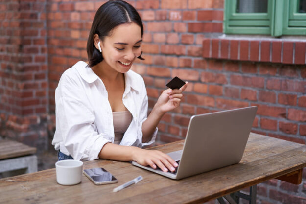 Woman donor with credit card and laptop