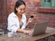 Woman donor with credit card and laptop