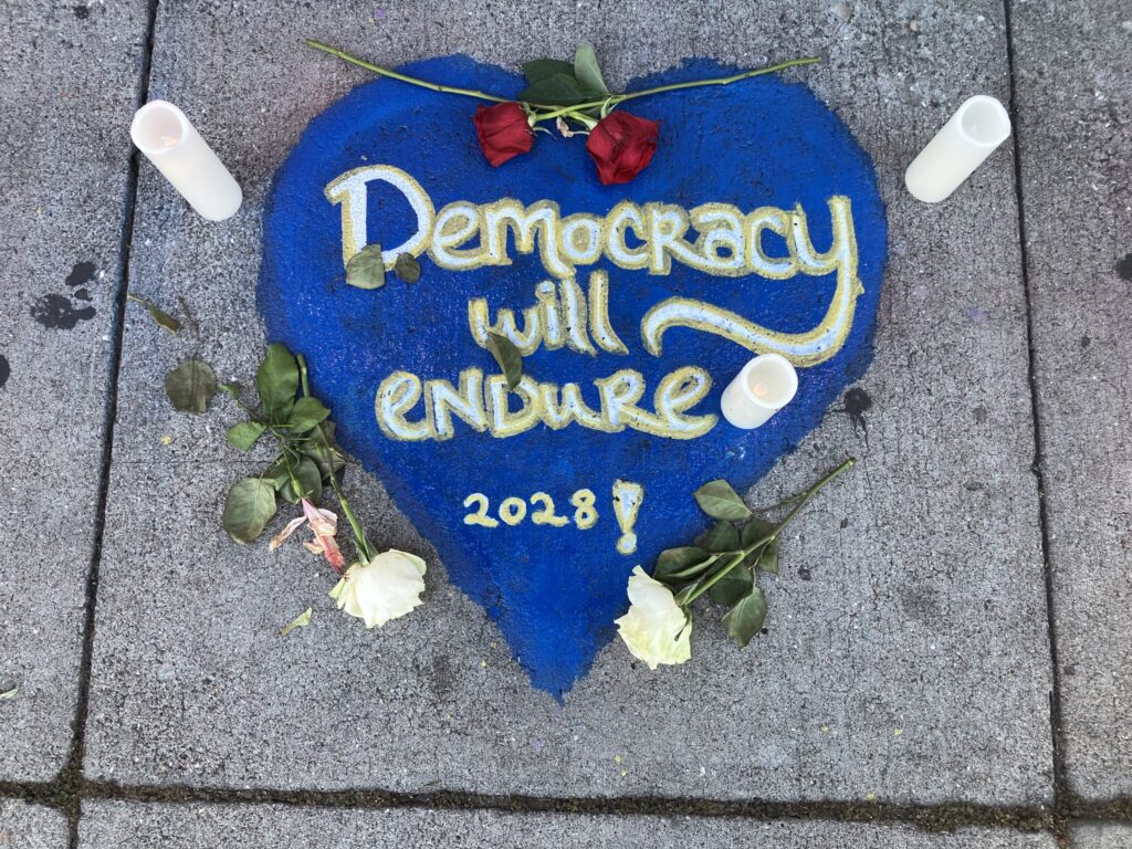 "Democracy will Endure" tribute and prayer found on a sidewalk.