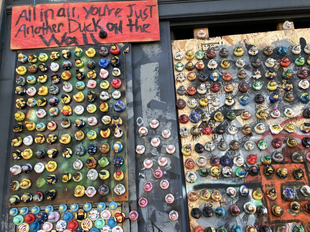 Wall mural/collage of many rubber duckies.