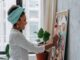 Woman planning, pinning images to a bulletin board