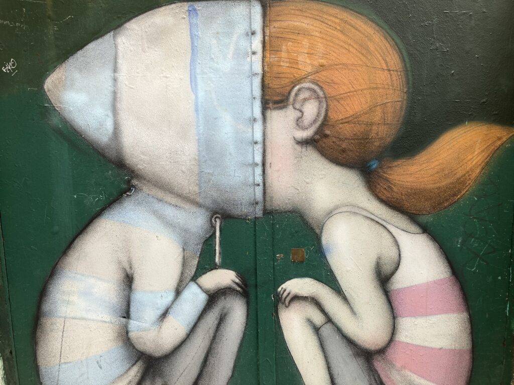 Droll street art on the side of a door in Paris.