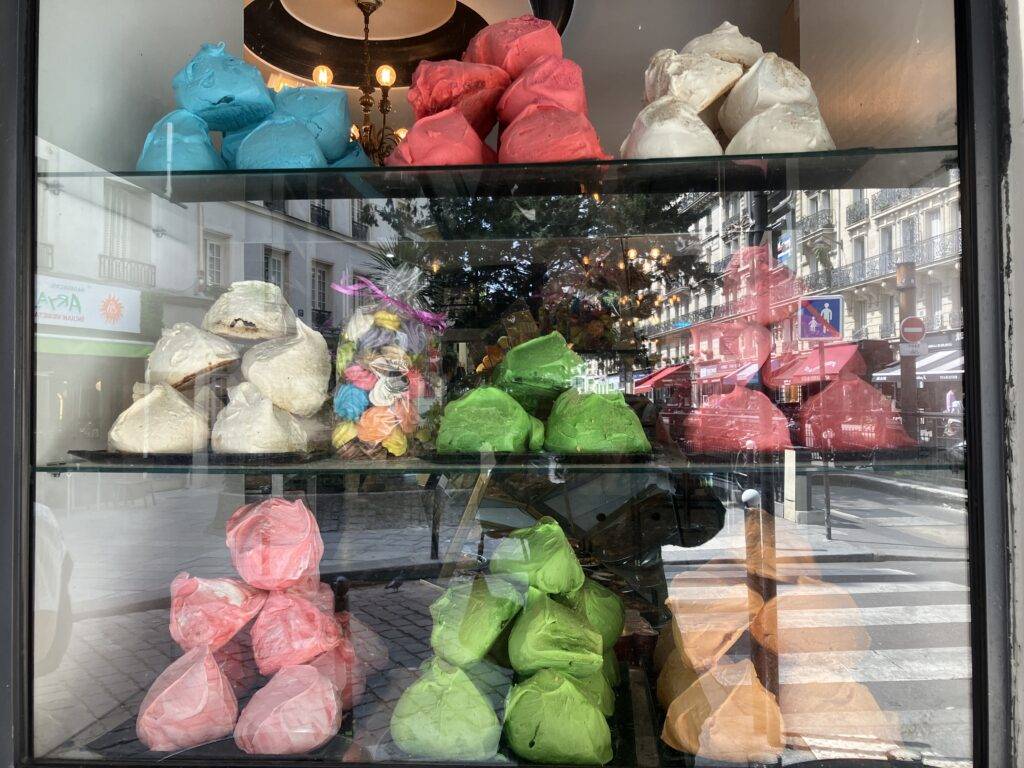 Parisian window display of colorful macarons.