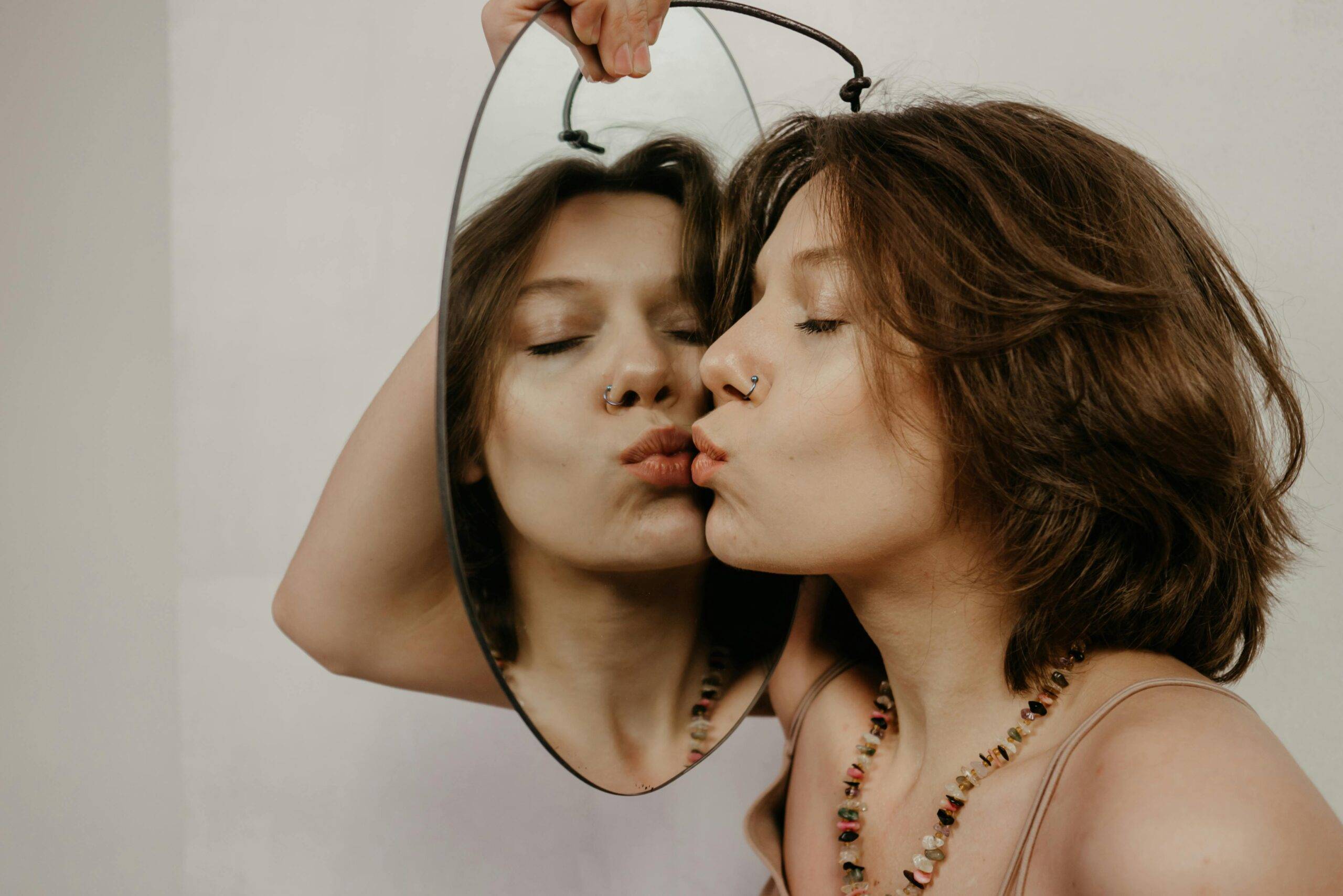 Mirror image woman pexels-polina-kovaleva Woman kissing reflection in mirror