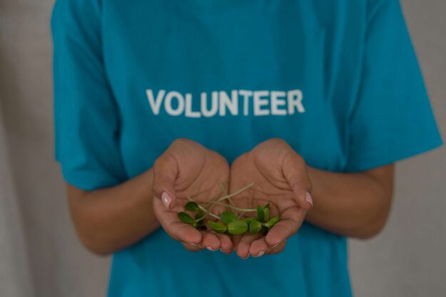 Volunteer holding handful of seeds