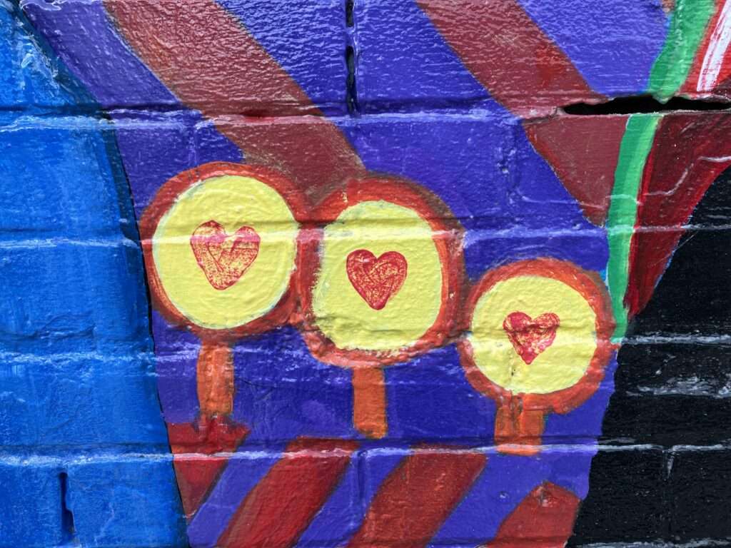 3 hearts painted on an outdoor wall