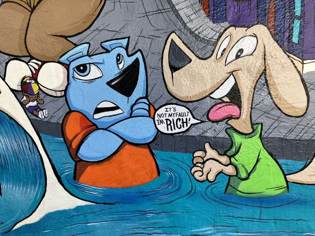 Political commentary cartoon painted on an exterior wall. More dogs.